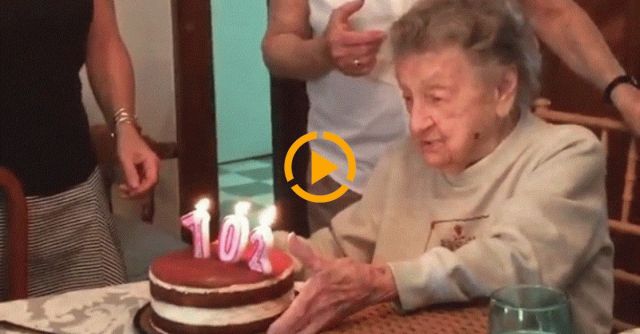 102 Yr Old Lady Blowing Out Her Birthday Candles.