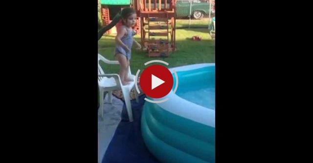 Little Girl Rolls Around Edge Of Inflatable Pool